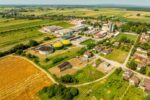 Aerial shot of Hercegovac, Croatia, showing industrial and agricultural landscape.